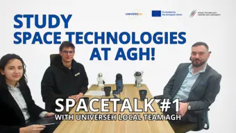 Three people sitting next to the table with microphone on it