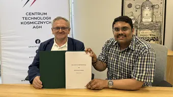 Zdjęcie dwóch osób siedzących za stołem.